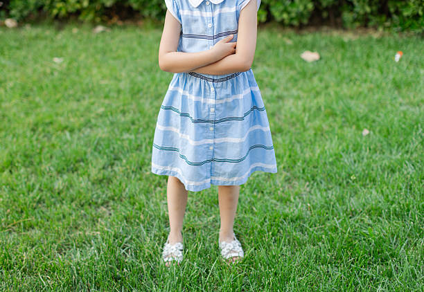 Little Girl Standing on Grass with Sandals