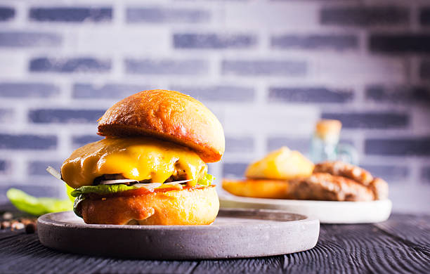 istock Close up cheese burger on wooden background. 2221862286