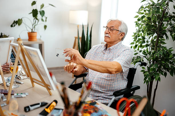 istock Senior man painting at nursing home 2221864500