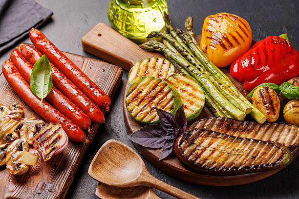 istock Assorted grilled vegetables including bell peppers, zucchini, eggplant, and sausages 2221864648