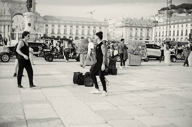 Lisbon, Portugal - Mars 16, 2024: A street musician performs at the Praça do Comércio square in Lisbon downtown.