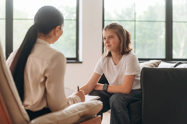 istock Sitting and writing. Girl at a psychologist's appointment 2221865953