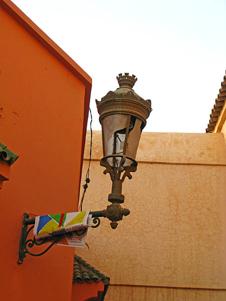 Close up view of an old traditional street lamp hanging over city entrance. Night in Marrakech, Morocco.