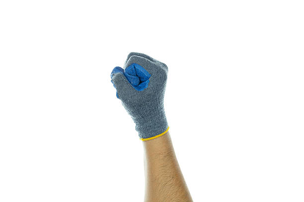 istock Hand in protective work glove forming a powerful fist, symbolizing strength and effort in manual tasks. Ideal for themes of labor and safety. isolated on white background with clipping path. 2221870212