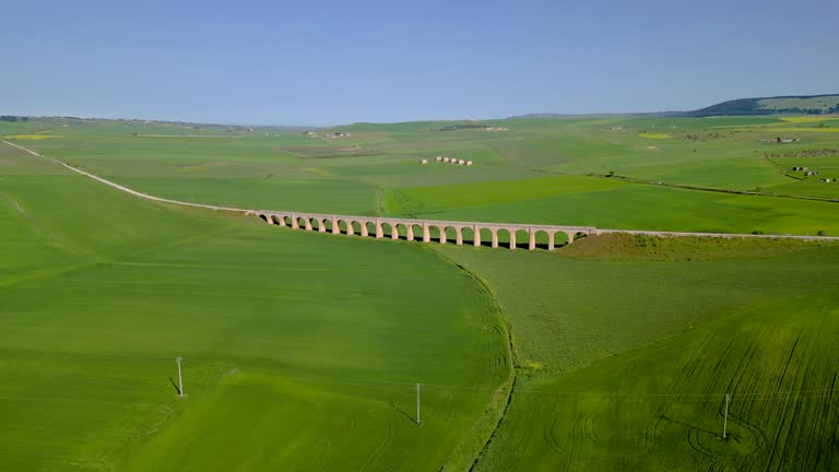 Ponte dei 21 Archi in Spinazzola, Puglia – Historic Railway Viaduct between Green Fields under Blue Sky. Italian Rural Architecture, Spring Landscape.