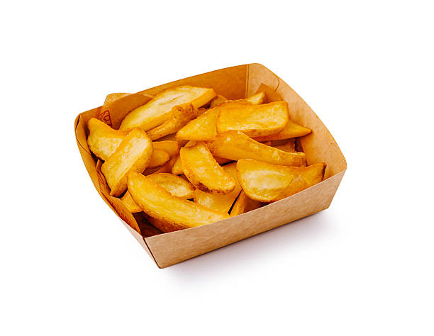 istock Crispy potato wedges served in a cardboard container at a casual dining setting 2221873644