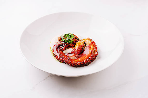 istock Octopus dish presented beautifully on a white plate with garnish 2221874146