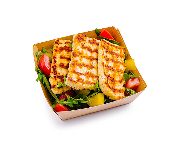 Grilled chicken strips are served on a bed of fresh greens mixed with colorful diced vegetables. The dish showcases vibrant toppings, creating a healthy and appetizing meal option.