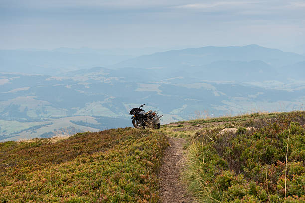 Slavsko , Ukraine - July 13, 2025: Slavsko , Ukraine - July 13, 2025: A group of motorcyclists ascends a dirt road on a hill, enjoying an active recreation in the fresh air.