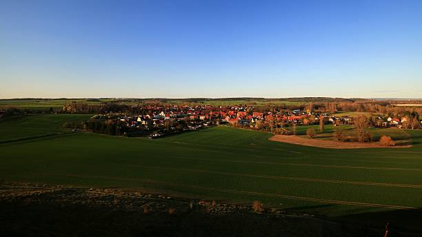 istock Village Weddersleben amid fields viewed from elevation in the evening near the Teufelsmauer, Harz mountains 2221877142