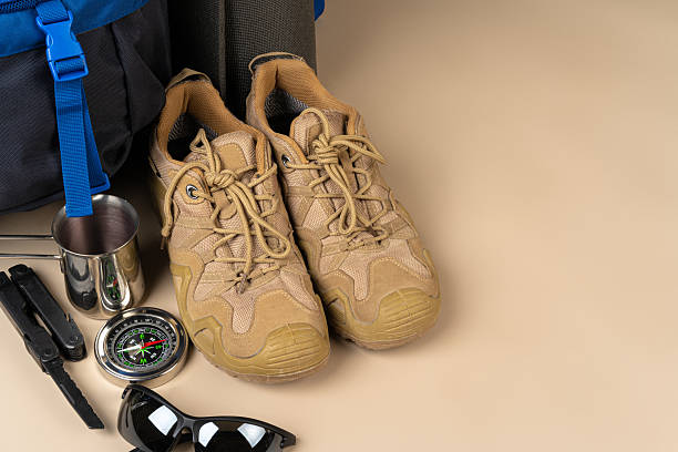 istock Blue backpack and hiking boots. Mountain gear close up 2221880108