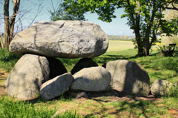 istock Large dolmen Hoher Stein in Germany under leafy trees in a clearing near open fields and rural countryside 2221880195