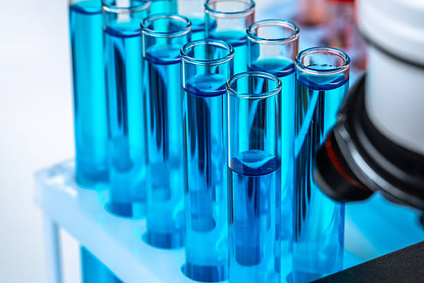istock Laboratory test tubes with blue liquid close up 2221880759