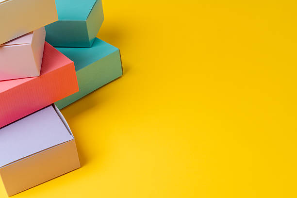 istock Colorful cardboard boxes on yellow background, copy space 2221881156
