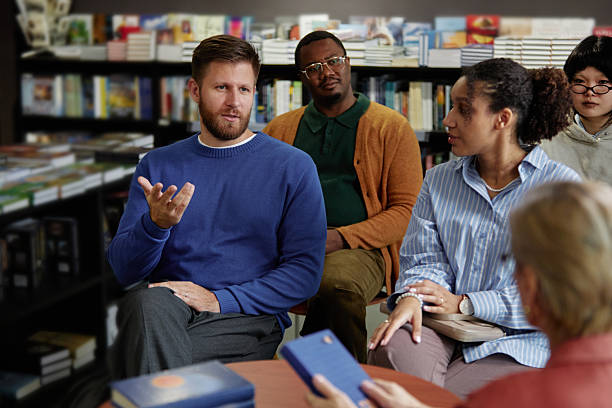 istock Diverse Group of Young Adults Engaging in Discussion during Meeting with Author 2221882399