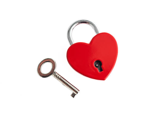 istock Red heart shaped padlock with silver key on white background 2221883561