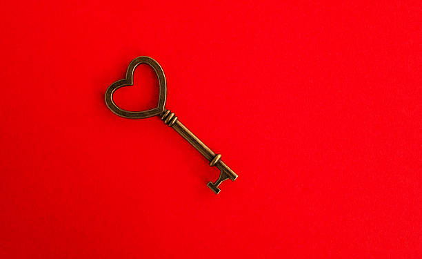 istock A heart shaped key on red background 2221883591