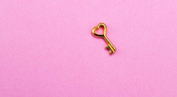 istock A heart shaped key on pink background 2221883652