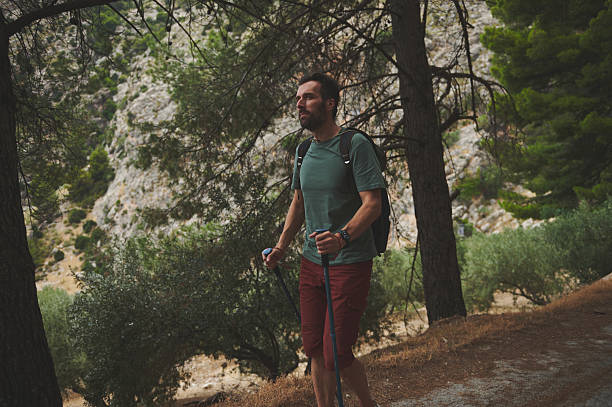 istock Male Hiker Enjoying Nature While Walking Through a Scenic Mountain Trail 2221883748