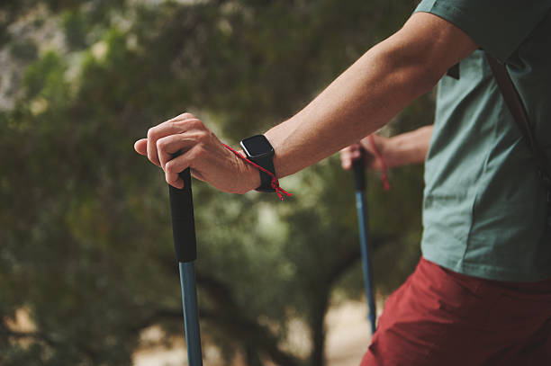 istock Close-Up of a Hiker Using Walking Sticks on a Nature Trail 2221883814