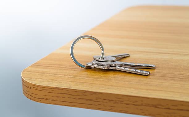 Bunch of silver keys on wooden table