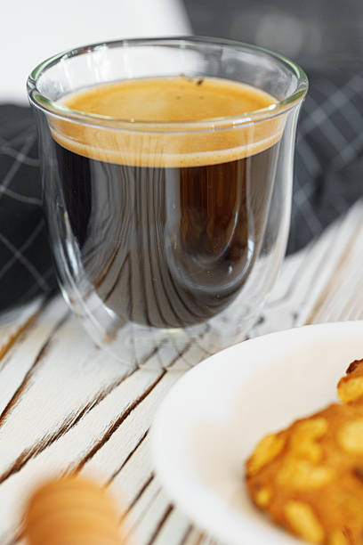 istock Glass cup of coffee on wooden kitchen table 2221883921