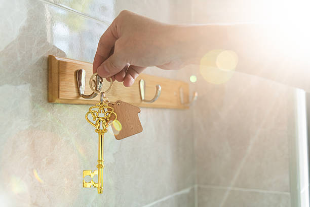 A set of car keys on a hook attached to a fridge