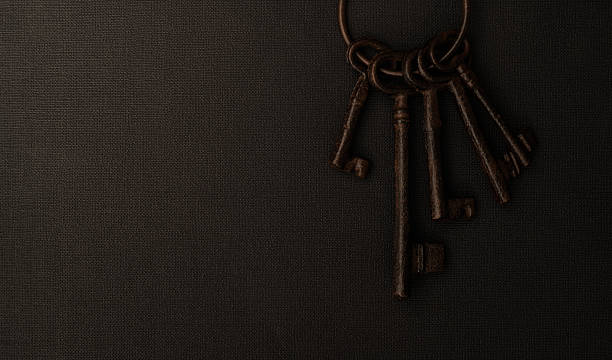 istock Bunch of old keys on black background 2221884231