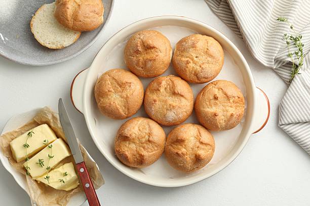 istock Flat lay composition with homemade tasty buns and butter on white table 2221888061