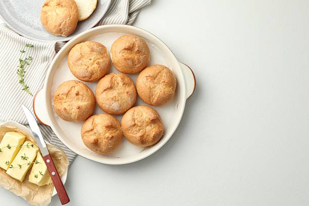 istock Flat lay composition with homemade tasty buns and butter on white table. Space for text 2221888152