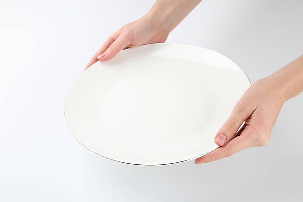istock Woman with empty ceramic plate on white background, closeup 2221888659
