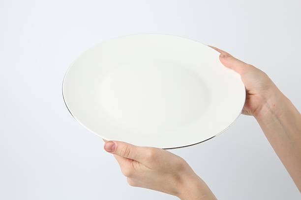 istock Woman with empty ceramic plate on white background, closeup 2221888665