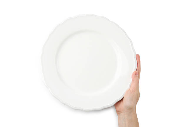 istock Woman with empty ceramic plate on white background, top view 2221888677