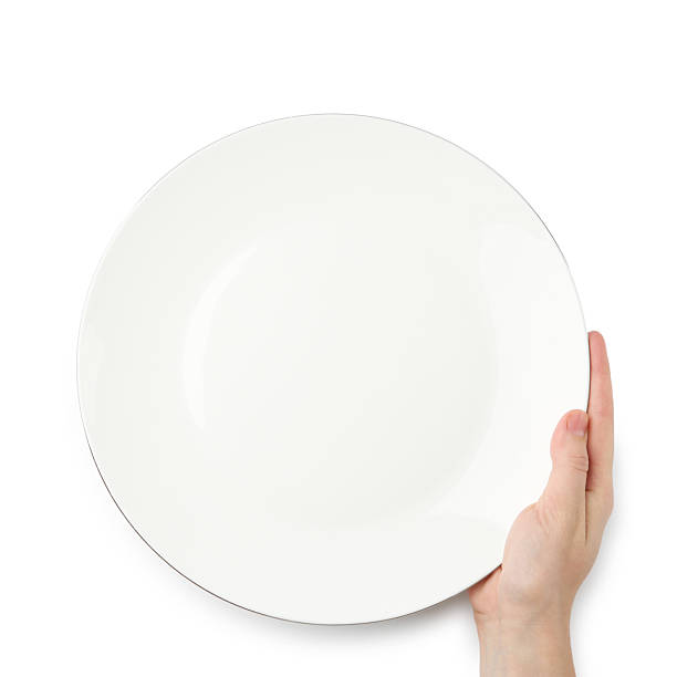 istock Woman with empty ceramic plate on white background, top view 2221888689