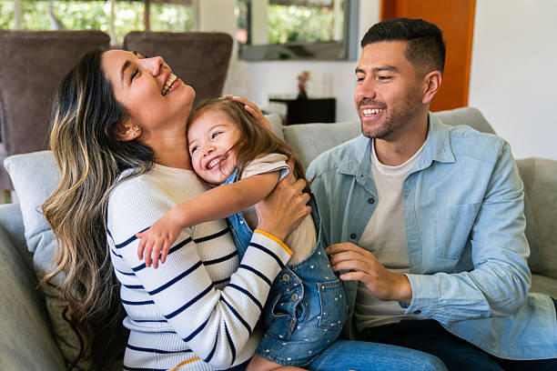 istock Happy family laughing while playing together at home 2221889486