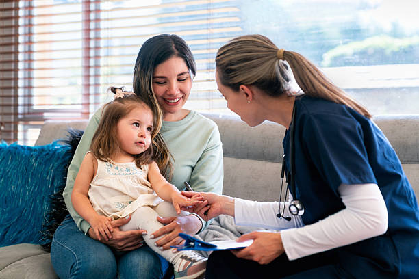 istock Pediatrician examining a girl while making a house call 2221889526