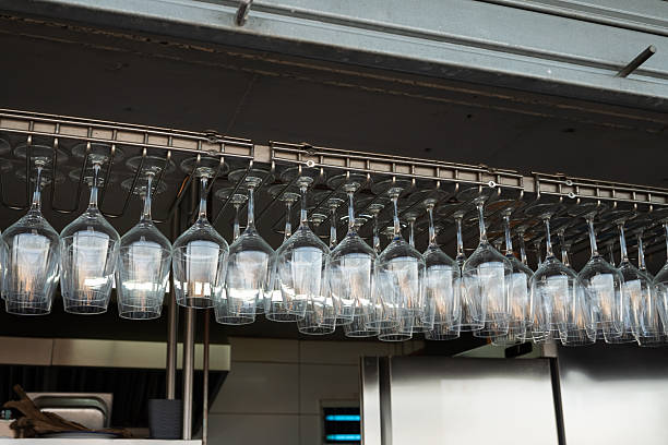 istock Upside-down wine glasses hanging on a rack in a restaurant kitchen 2221889598