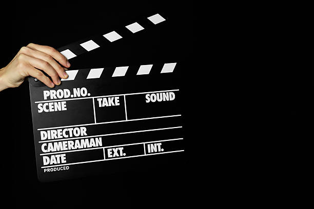 istock Woman with clapperboard on black background, closeup. Space for text 2221890076