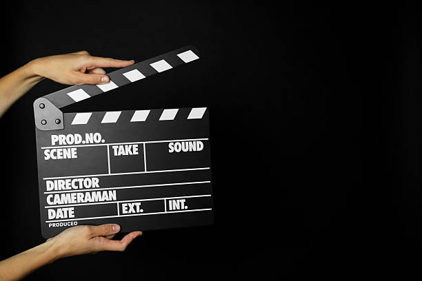 istock Woman with clapperboard on black background, closeup. Space for text 2221890078