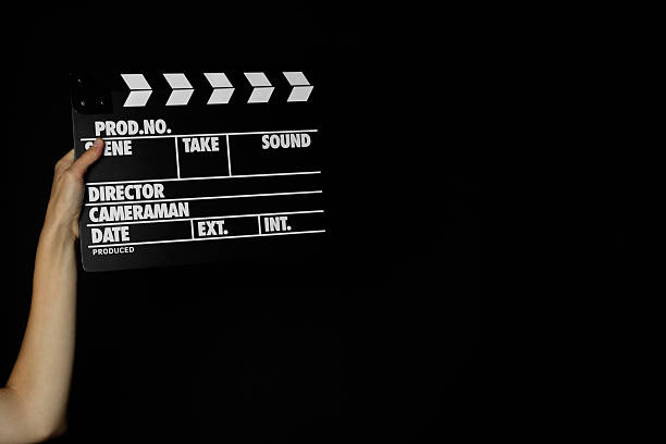 istock Woman with clapperboard on black background, closeup. Space for text 2221890092