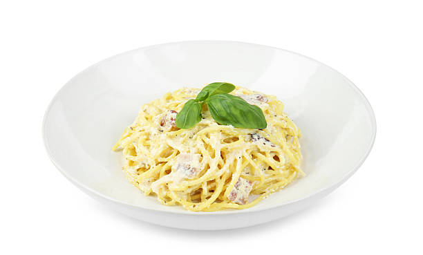 istock Delicious pasta Carbonara in bowl isolated on white 2221890237