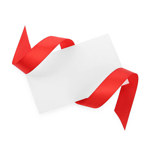 istock Blank card and red ribbon isolated on white, top view 2221890559