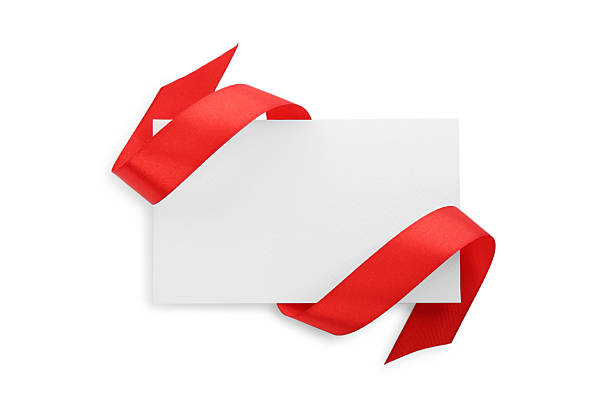 istock Blank card and red ribbon isolated on white, top view 2221890572
