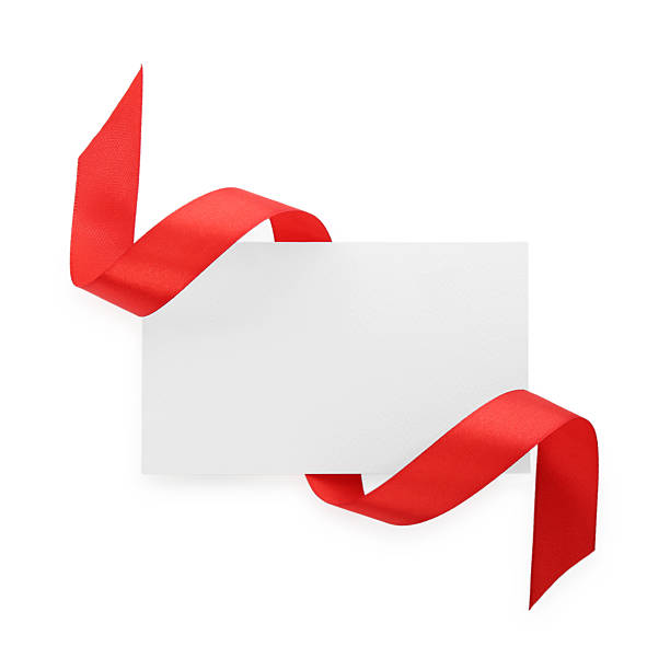 istock Blank card and red ribbon isolated on white, top view 2221890574