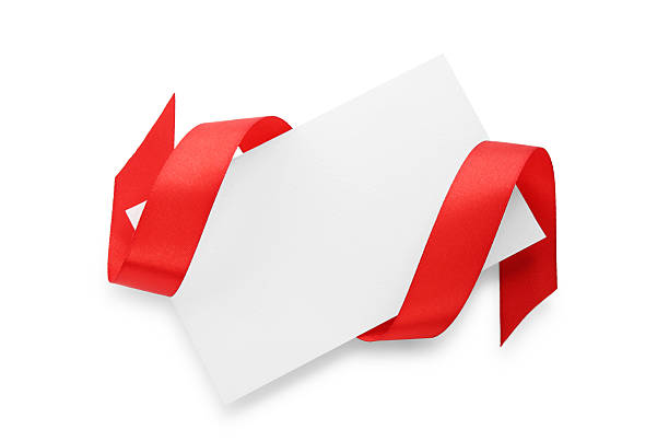 istock Blank card and red ribbon isolated on white, top view 2221890580