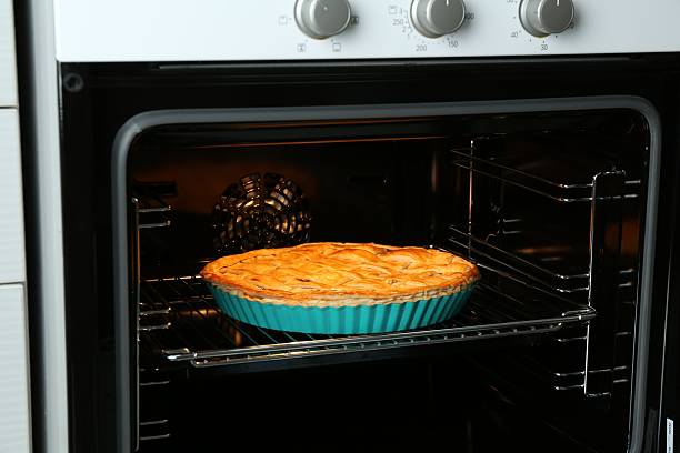 istock Baking dish with homemade apple pie in oven 2221890755