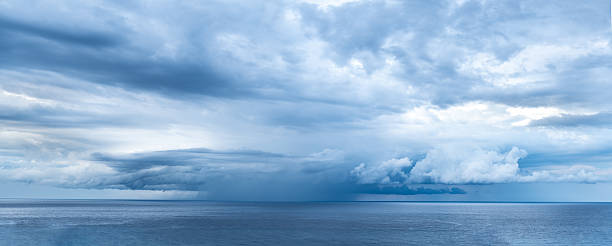 istock panorama of rain storm over the ocean 2221890822