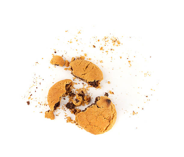 istock Crumbled chocolate cookies with chocolate filling isolated, brown round biscuits pieces 2221894076