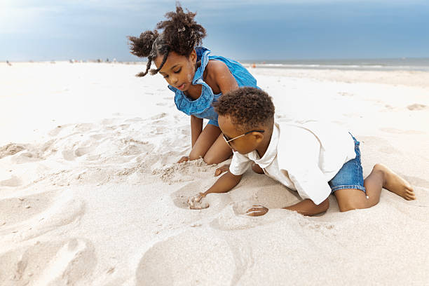 istock Beautiful diverse children enjoying down time on a beach holiday 2221894914