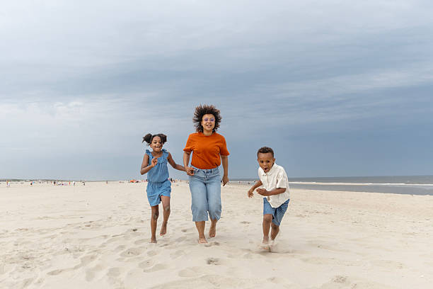 istock Diverse mother, daughter & son enjoying a Spring day on the beach 2221895171